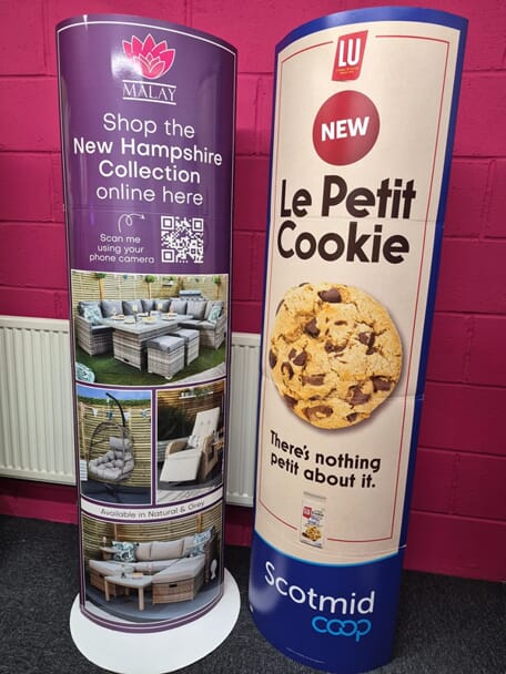 An image of signage for different businesses, including Le Petit Cooke.